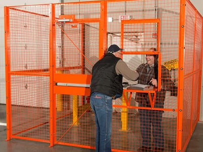 Orange Wire Partition with two employees shaking hands