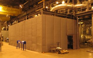 Equipment Noise Enclosure Gray Equipment Noise Enclosure in a warehouse
