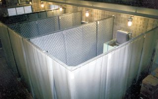 Noise Curtain Enclosures Gray Noise Curtain Enclosures with lightbulbs above each section