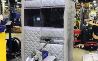 Process Noise Enclosure Gray Process Noise Enclosure in a warehouse