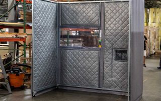 Three-Sided Noise Enclosure Gray Three-Sided Noise Enclosure in a warehouse